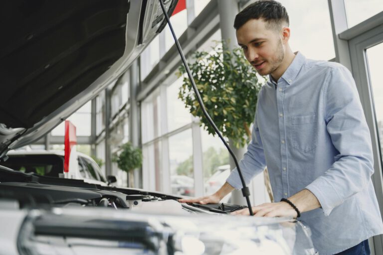 Man in Long Sleeves Looking at the Engine bay